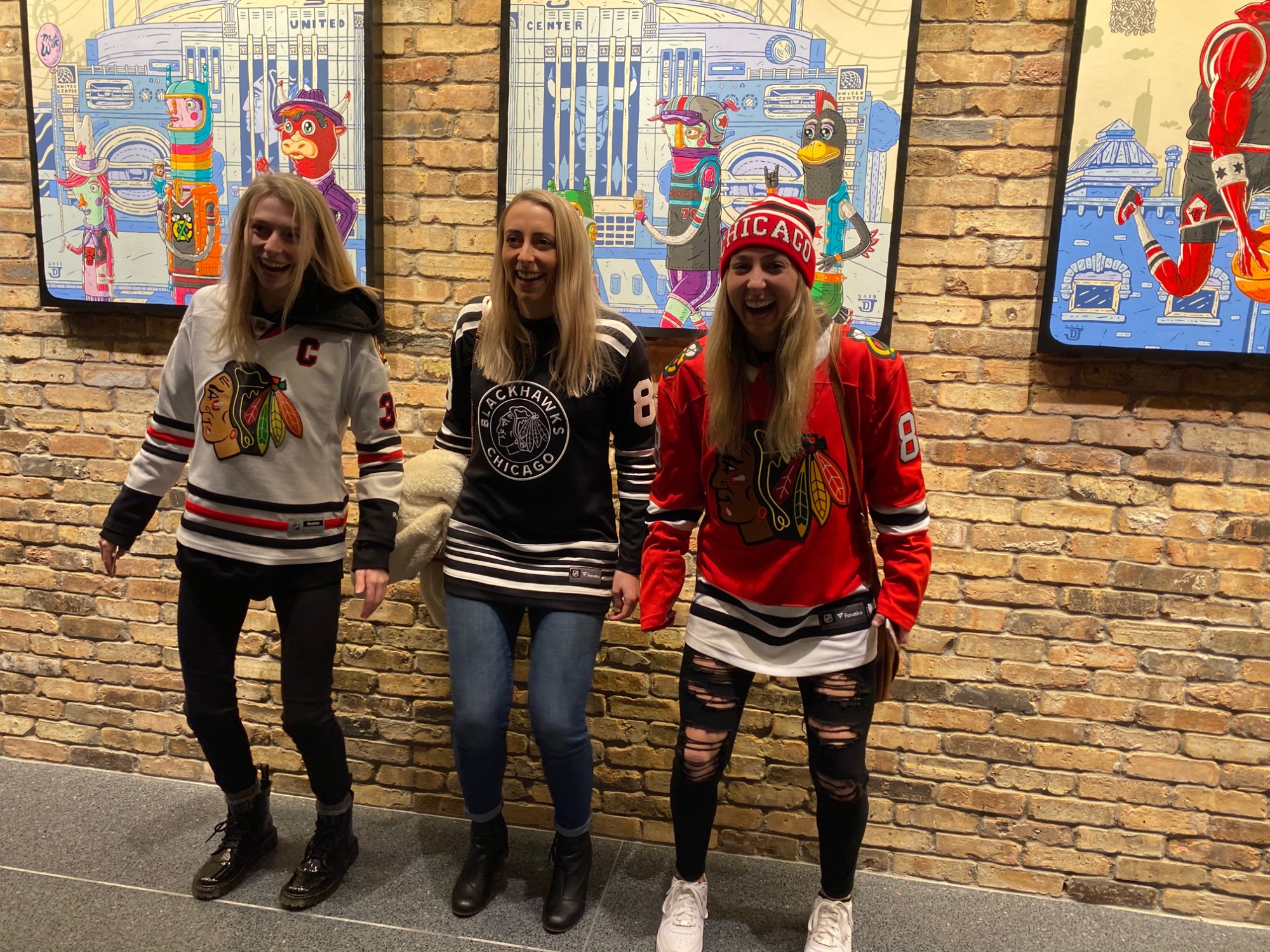 Three women all sisters wearing Chicago Blackhawk jerseys